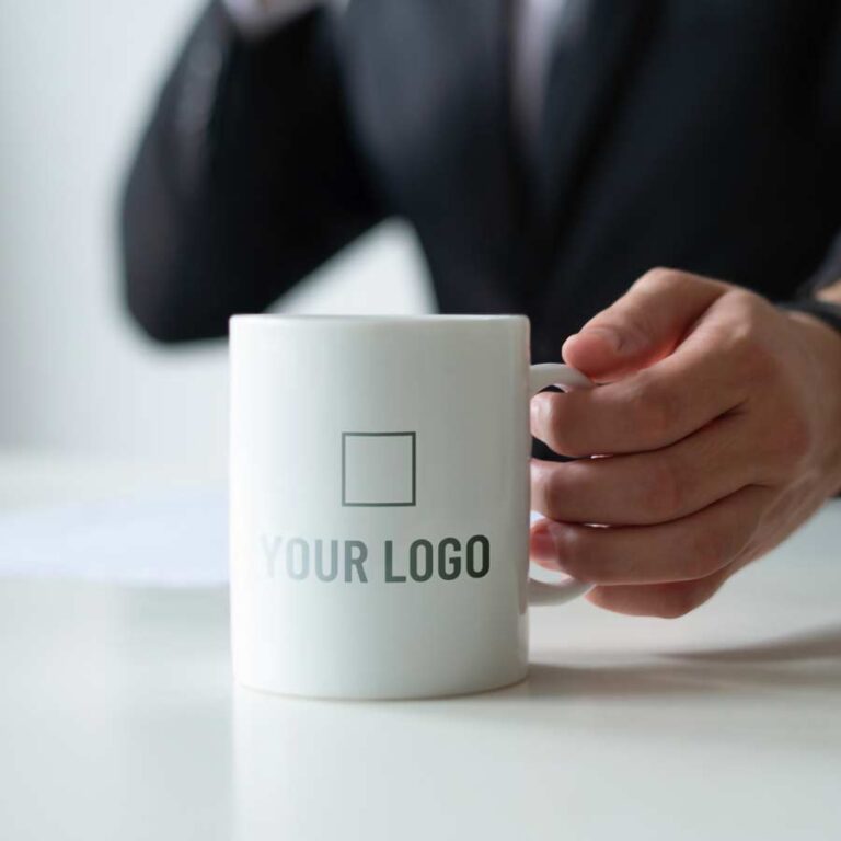 Custom branded coffee mug with company logo.